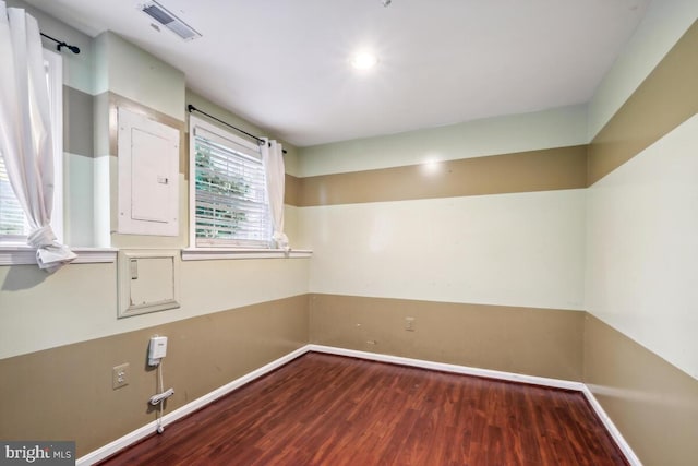 unfurnished room with wood finished floors and baseboards
