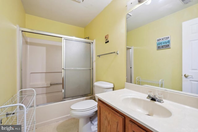 bathroom with toilet, vanity, bath / shower combo with glass door, and tile patterned floors