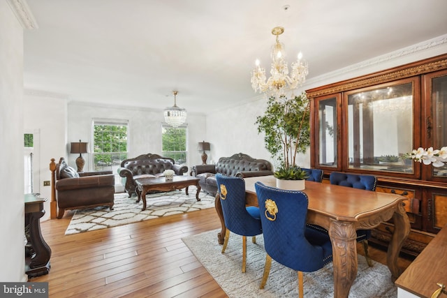 dining area featuring a chandelier, hardwood / wood-style floors, and ornamental molding