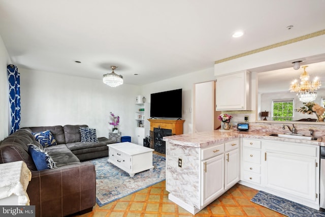 living room with a chandelier, recessed lighting, and light floors