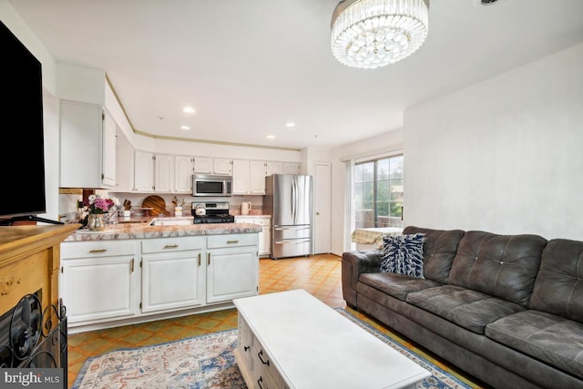 living room featuring a chandelier and recessed lighting