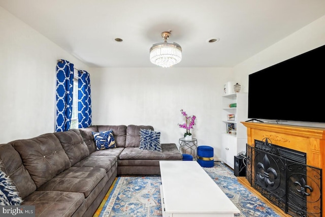 living area featuring a chandelier and a fireplace