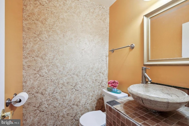 half bath with a sink and toilet