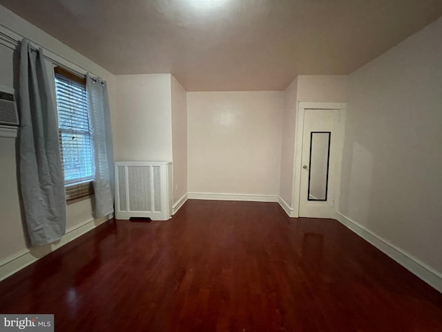 bonus room with wood finished floors and baseboards