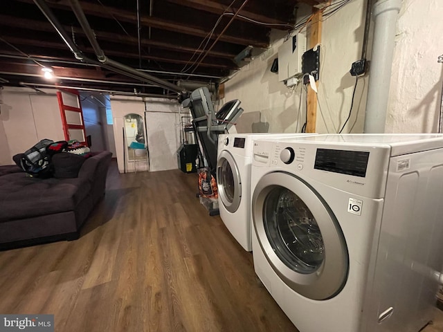 laundry room with wood finished floors and washing machine and dryer