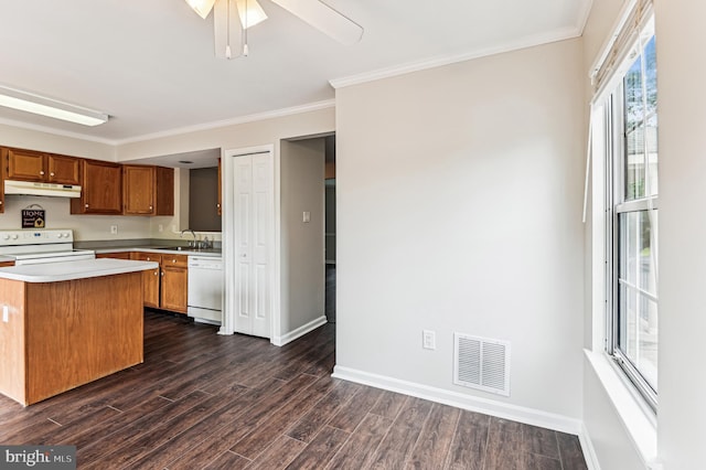 1372 Walkabout Ct Unit 53, Eldersburg, MD 21784 - kitchen with under cabinet range hood, white appliances, a sink, light countertops, and dark wood-style floors