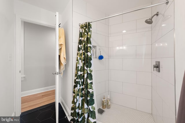 full bathroom featuring a tile shower and tile patterned floors
