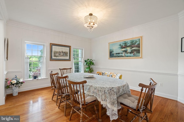 7814 Abbey Oaks Ct, Manassas, VA 20112 - dining room with a chandelier, light wood-style floors, crown molding, and baseboards