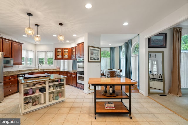 7814 Abbey Oaks Ct, Manassas, VA 20112 - kitchen with white microwave, stainless steel double oven, a sink, recessed lighting, and healthy amount of natural light