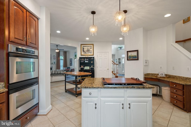 7814 Abbey Oaks Ct, Manassas, VA 20112 - kitchen with double oven, cooktop, light tile patterned floors, white cabinetry, and dark stone countertops