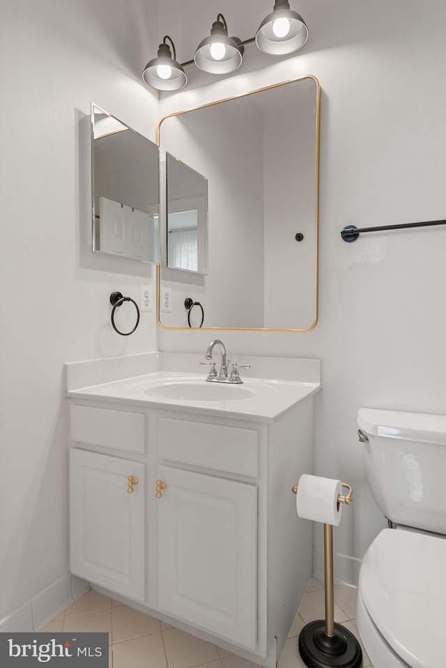 7814 Abbey Oaks Ct, Manassas, VA 20112 - bathroom featuring tile patterned flooring, baseboards, toilet, and vanity