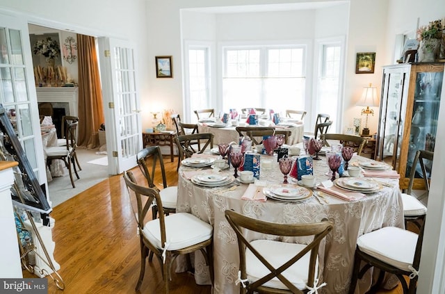 7814 Abbey Oaks Ct, Manassas, VA 20112 - dining room featuring light wood finished floors and a fireplace