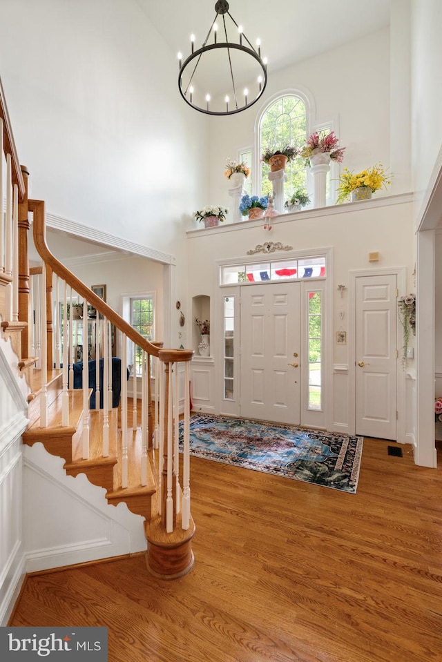 7814 Abbey Oaks Ct, Manassas, VA 20112 - entrance foyer featuring a high ceiling, stairs, wood finished floors, and a chandelier