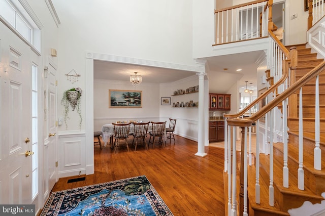 7814 Abbey Oaks Ct, Manassas, VA 20112 - foyer with a high ceiling, stairs, wood finished floors, ornate columns, and a wainscoted wall