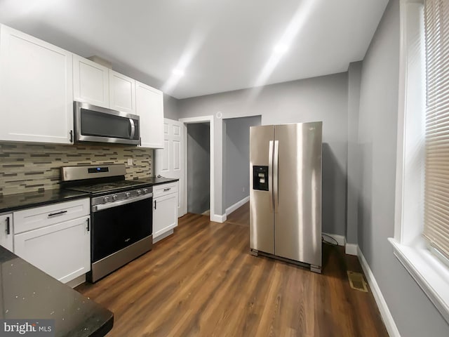2059 E Atlantic St, Philadelphia, PA 19134 - kitchen with appliances with stainless steel finishes, decorative backsplash, baseboards, and dark wood-style flooring