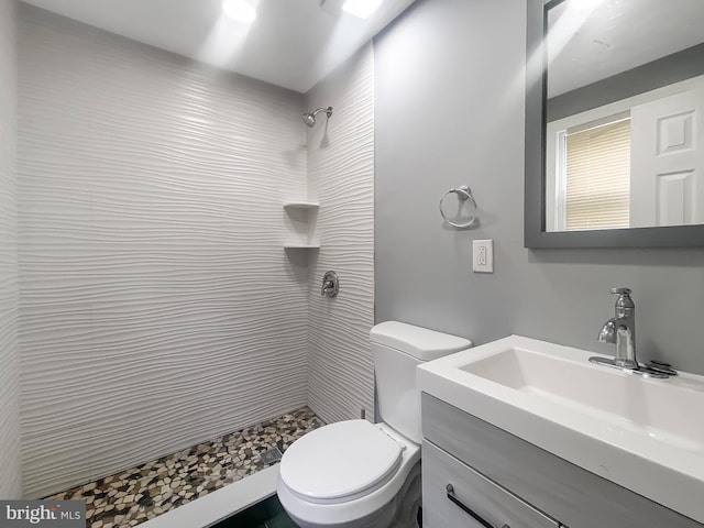 2059 E Atlantic St, Philadelphia, PA 19134 - bathroom featuring a tile shower, toilet, and vanity