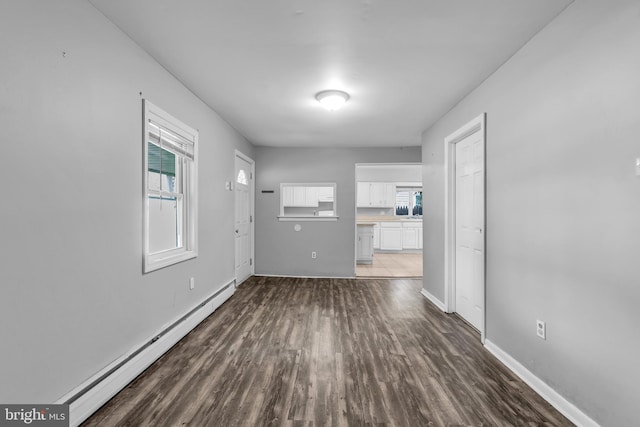 102 Sunset St, Browns Mills, NJ 08015 - spare room with baseboard heating, dark wood-style flooring, healthy amount of natural light, and baseboards
