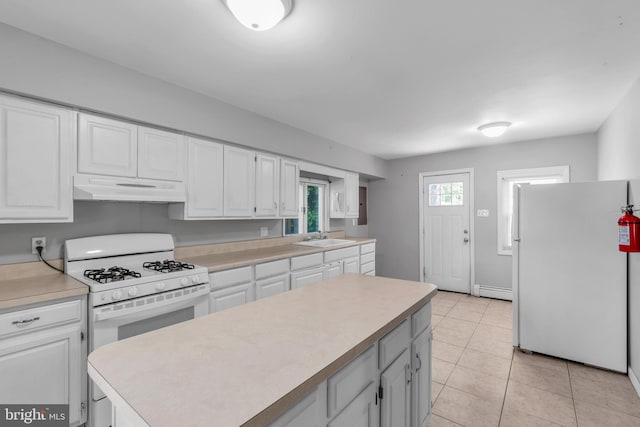 102 Sunset St, Browns Mills, NJ 08015 - kitchen featuring white appliances, under cabinet range hood, a sink, white cabinets, and light countertops