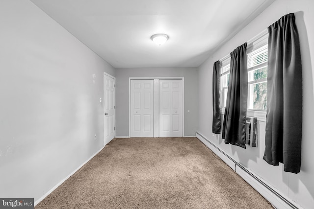 102 Sunset St, Browns Mills, NJ 08015 - unfurnished bedroom with a baseboard heating unit, carpet, a closet, and baseboards