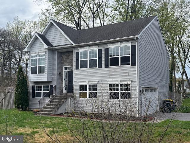 split foyer home with an attached garage and driveway