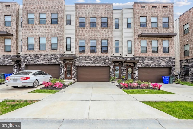 multi unit property with a garage and driveway