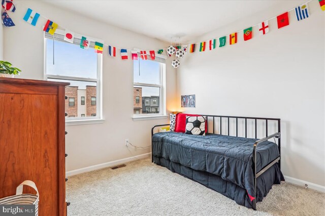 bedroom with carpet floors and baseboards