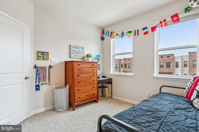 carpeted bedroom with baseboards