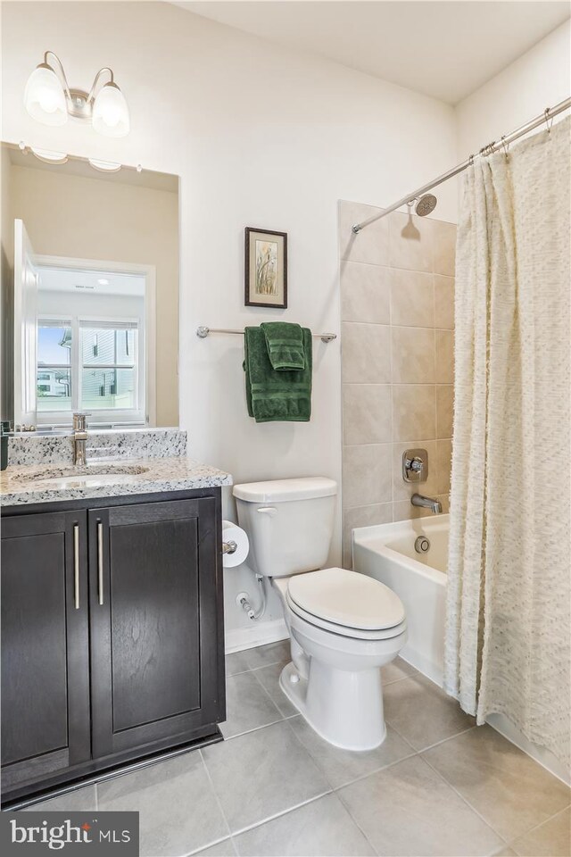 bathroom featuring toilet, tile patterned flooring, shower / bathtub combination with curtain, and vanity
