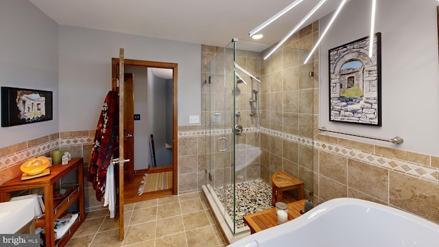 955 Lucabaugh Mill Rd, Westminster, MD 21157 - bathroom featuring tile walls, a shower stall, a bath, tile patterned flooring, and a wainscoted wall
