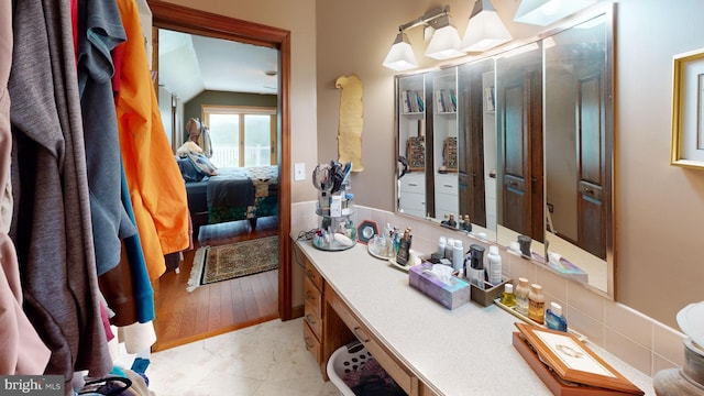 955 Lucabaugh Mill Rd, Westminster, MD 21157 - ensuite bathroom with vanity, lofted ceiling, backsplash, and marble look tiles