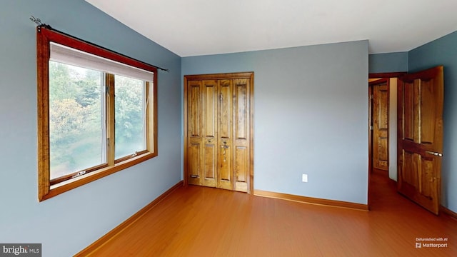 955 Lucabaugh Mill Rd, Westminster, MD 21157 - unfurnished bedroom with wood finished floors, baseboards, and a closet