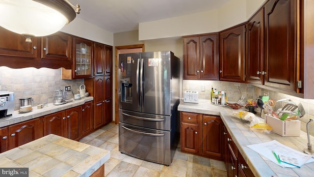 955 Lucabaugh Mill Rd, Westminster, MD 21157 - kitchen with stainless steel refrigerator with ice dispenser, tile counters, tasteful backsplash, and glass insert cabinets