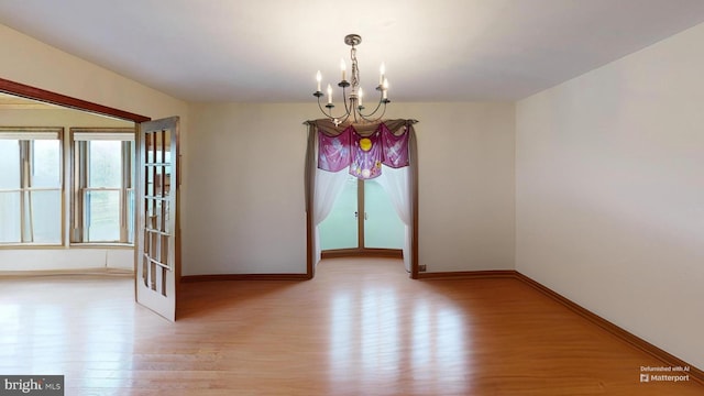955 Lucabaugh Mill Rd, Westminster, MD 21157 - spare room featuring light wood-type flooring, a chandelier, and baseboards