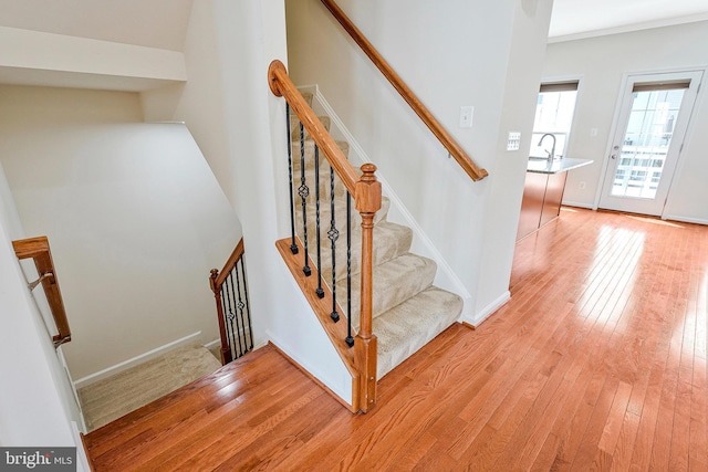 stairway with hardwood / wood-style flooring and baseboards