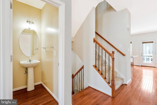 stairway featuring hardwood / wood-style flooring and baseboards