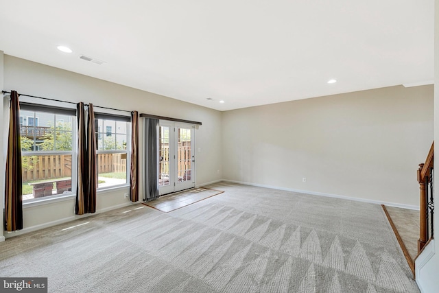 spare room with carpet flooring, baseboards, and recessed lighting