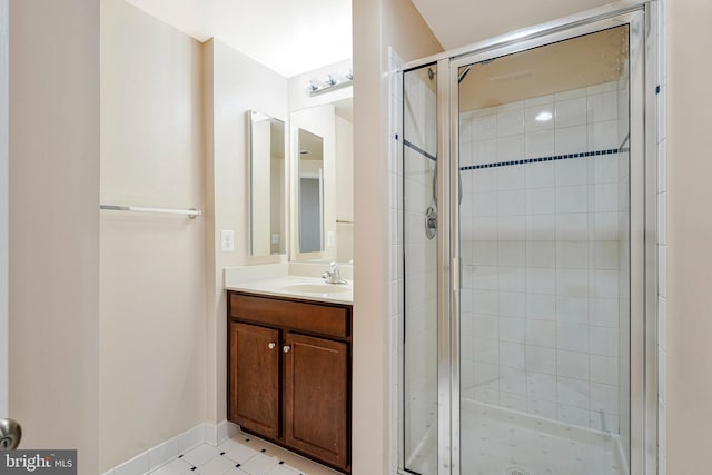 bathroom featuring a shower stall, vanity, and baseboards