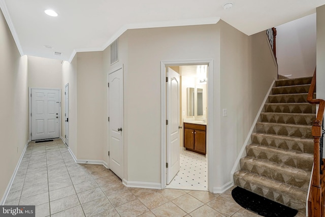 hall featuring stairs, baseboards, light tile patterned flooring, ornamental molding, and recessed lighting