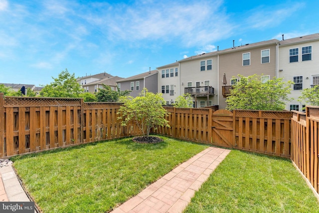 view of yard featuring a residential view and a gate