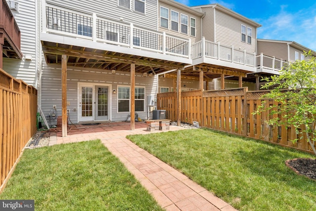 rear view of property with cooling unit, a patio, and a wooden deck
