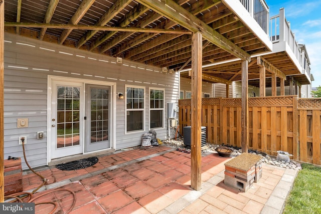 view of patio / terrace featuring fence and central AC unit