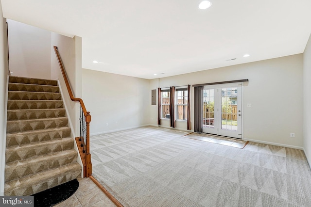 spare room with light carpet, stairway, recessed lighting, and baseboards