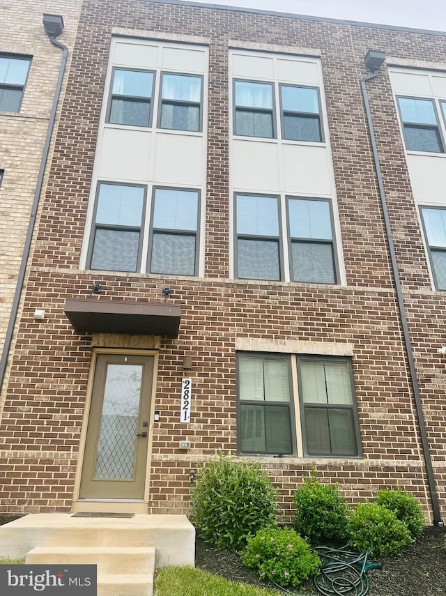 view of front of home featuring brick siding