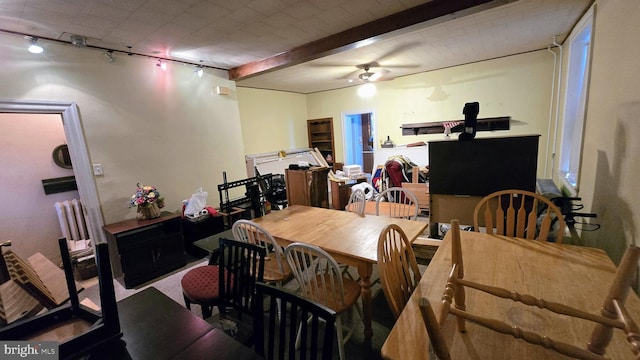dining room featuring track lighting, ceiling fan, and beam ceiling