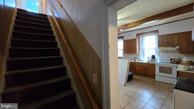 staircase featuring tile patterned flooring