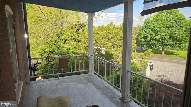 balcony featuring a view of trees