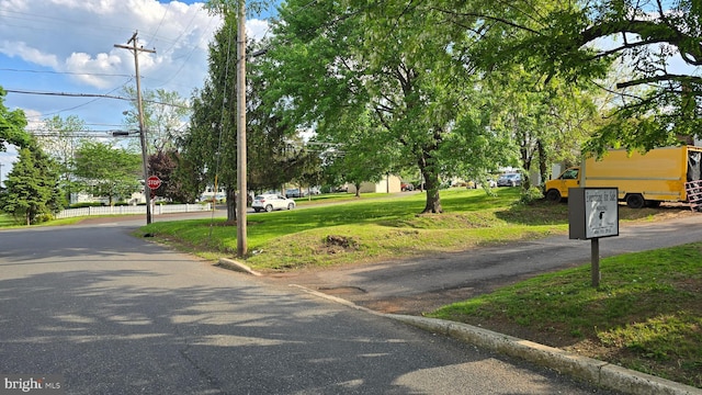 view of asphalt street featuring traffic signs