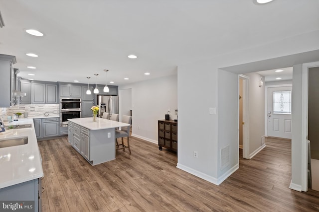 6281 Hidden Clearing, Columbia, MD 21045 - kitchen featuring gray cabinetry, appliances with stainless steel finishes, light countertops, tasteful backsplash, and recessed lighting