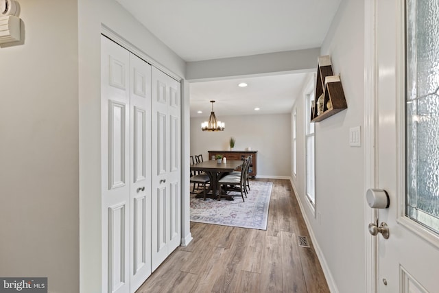 6281 Hidden Clearing, Columbia, MD 21045 - hallway with wood finished floors, recessed lighting, a chandelier, plenty of natural light, and baseboards