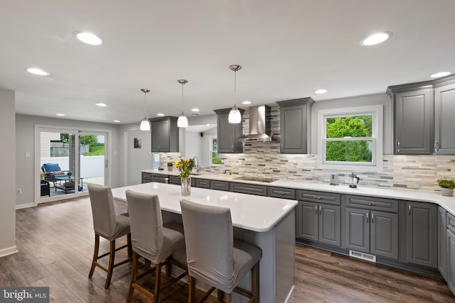 6281 Hidden Clearing, Columbia, MD 21045 - kitchen featuring wall chimney exhaust hood, gray cabinets, black electric stovetop, backsplash, and recessed lighting